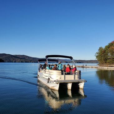 People enjoying a sunny boat ride on a calm lake.