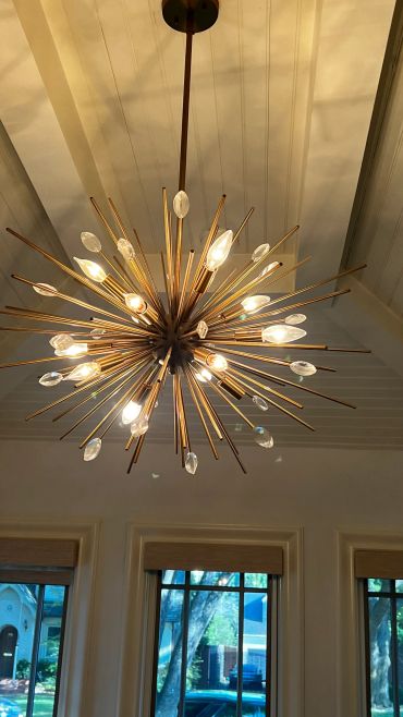 Decorative starburst chandelier with multiple lights.