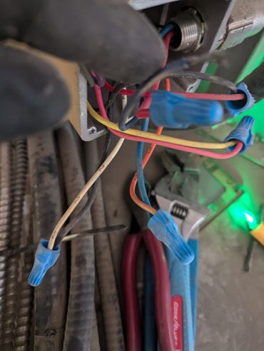 wires with wire nut connecting electricity to an electrical device