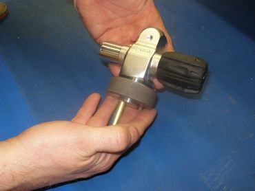 Using a GO ring-gauge to check the threads of a valve stem