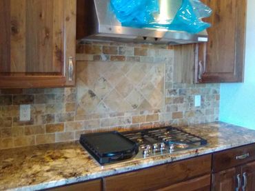 Kitchen backsplash with 2 x 6 and 6 x 6 tumbled travertine tiles laid on a 45 degree angle