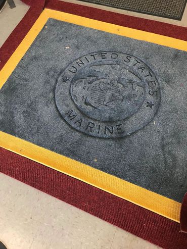 Marine Corps logo carved into rug with double border