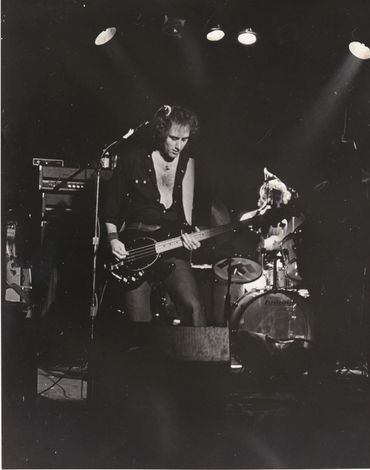 Ric playing bass at a live venue, likely at the Channel Concert Club.