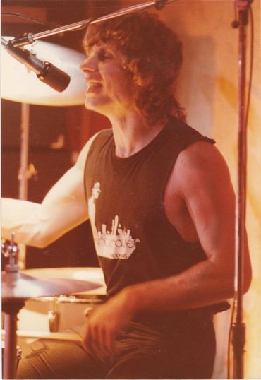 Phil playing drums and singing.