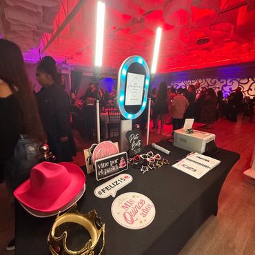Photo booth setup for a quinceañera with props and lights.
