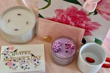 Mother's Day setup with candles, card, and floral decor.