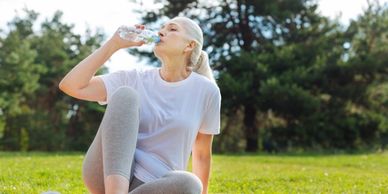 A woman hydrates after exercise