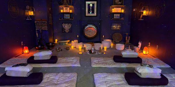 A serene meditation room with cushions, candles, and calming decor.
