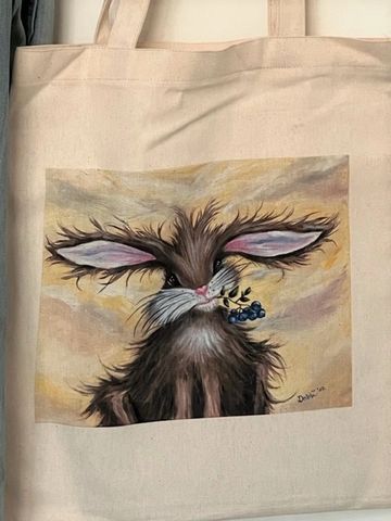 Canvas tote bag featuring a WhimzyWorks original painting of a whimsical bunny holding blueberries.