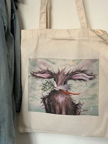 Canvas tote bag featuring a WhimzyWorks original painting of a whimsical bunny holding a carrot.
