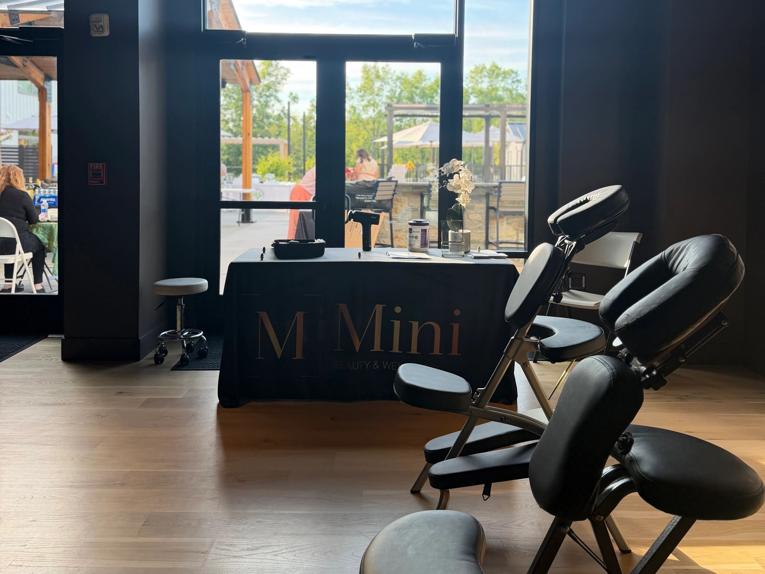 Spa or wellness area with massage chairs and a table.