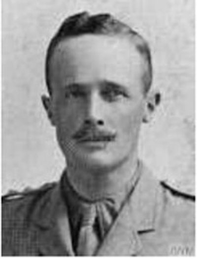 Black and white portrait of a man in military uniform with a mustache.