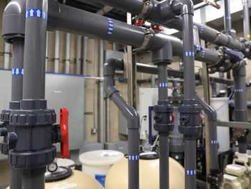 Commercial pool equipment with pipes and sand filters