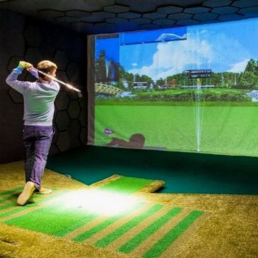 Person playing a golf arcade game at the Green Family Fun Zone.