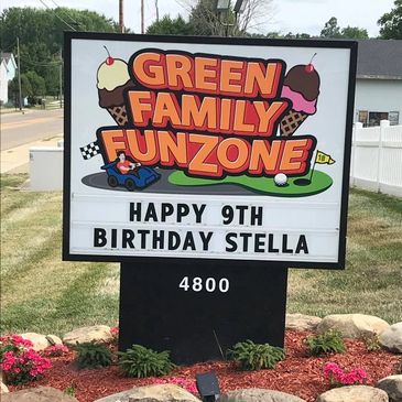 Green Family FunZone sign and birthday message by the road
