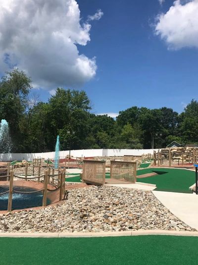 Green Family Fun Zone miniature golf course with water features.