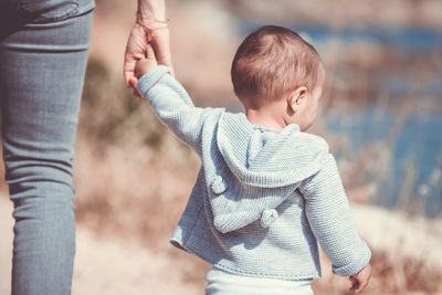 Child holding mother's hand