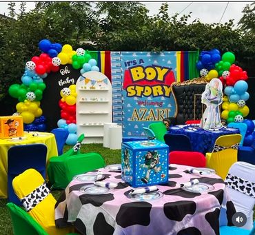 Colorful Toy Story themed baby shower setup with balloons and decorations.