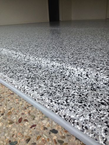 Close-up of a polished speckled epoxy floor with steps.