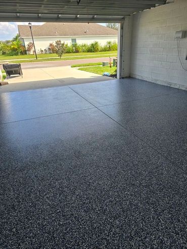 Clean, freshly coated garage floor with a speckled finish.