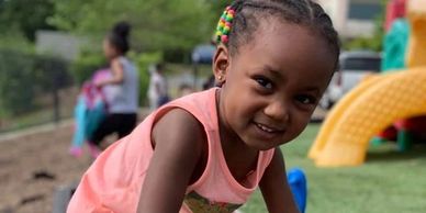 Smiling girl playing outdoors.
