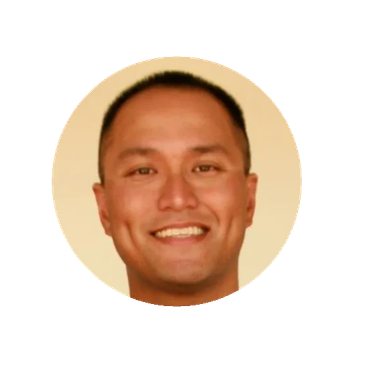 Smiling man with short hair in a circular frame.