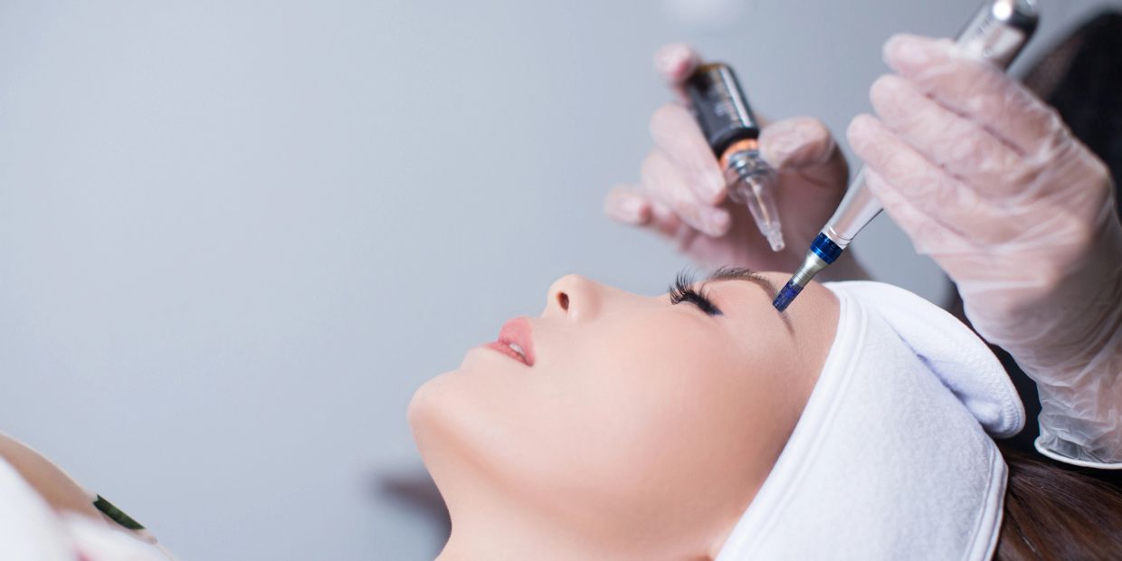 Woman receiving a cosmetic injection near her eye.