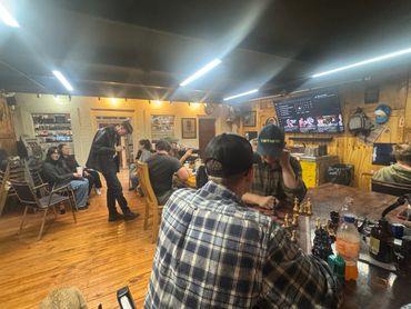 Guests relaxing and socializing in the smoking lounge at Mystery Shack Cigars & Coffee in Shallowate