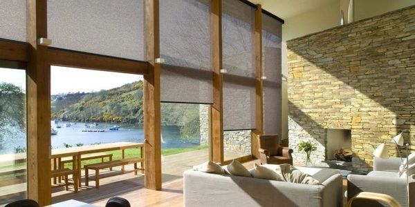 Light filtering roller shades in a living room facing the Ozark lake