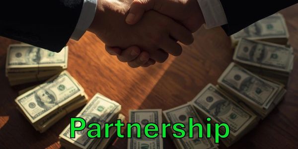 Two people shaking hands over stacks of money symbolizing partnership.