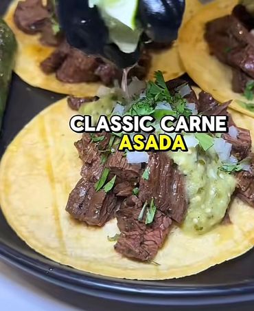 Classic carne asada tacos topped with fresh salsa and cilantro.