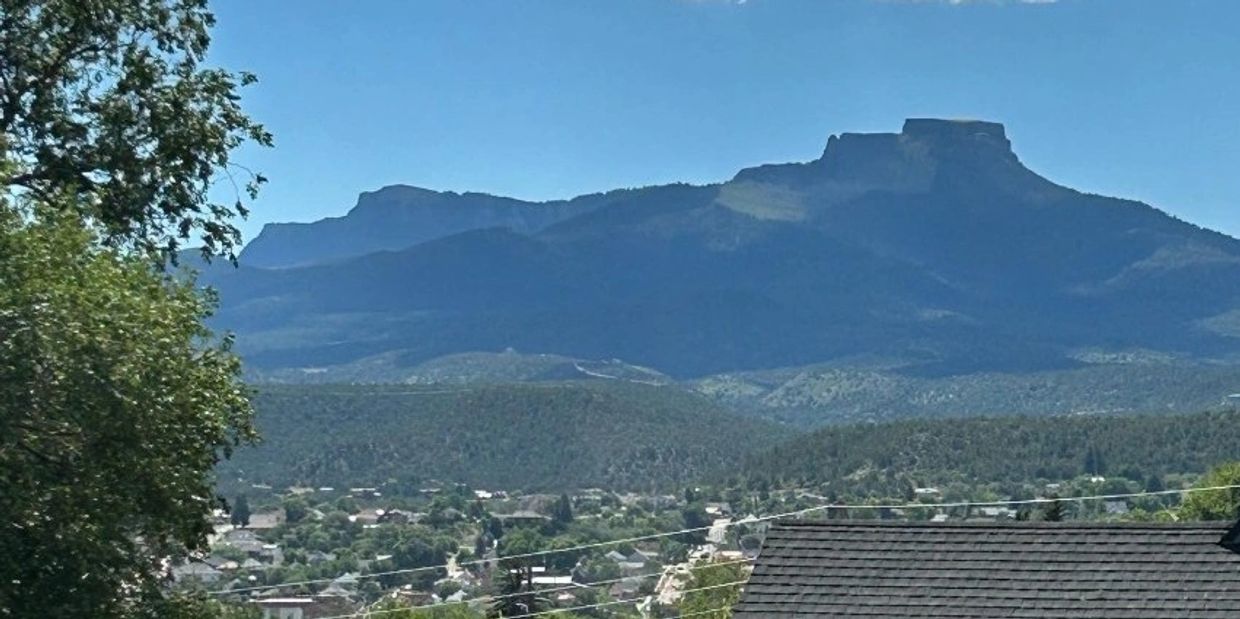 Mountain view over a town under a clear blue sky.