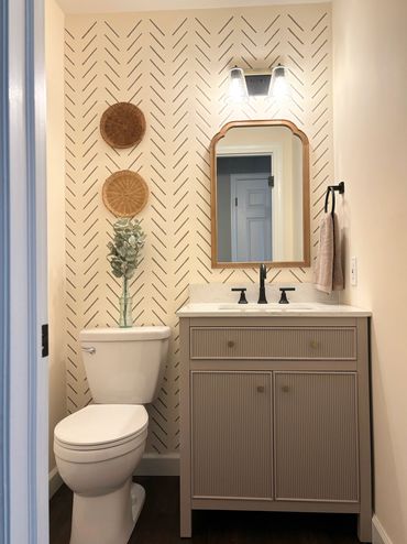 half bath remodeled with custom vanity, bright lighting, neutral wallpaper, interior painting