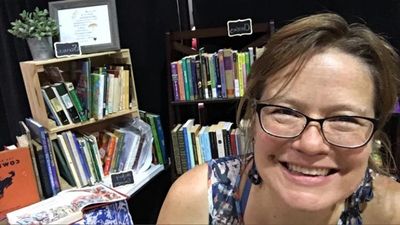 Heather Johnson  at the books stall of lovely living books at HERI, July 2019.