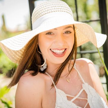 Portrait photography image of young woman wearing sun hat with bright eyes and big smile!