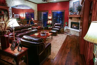 A red living room with leather couches and a sofa