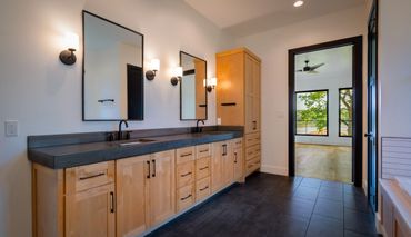 Wooden bathroom counters with two sinks and mirrors