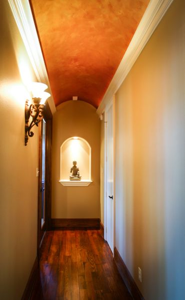 Hallway with a curved ceiling and a wall lamp
