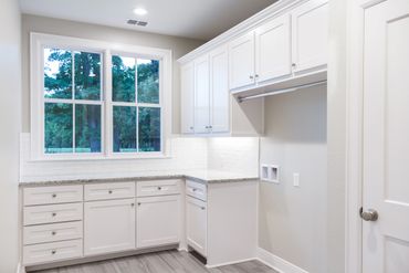 A room with white walls and cabinets