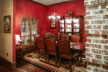 A red dining room with classic dining chairs