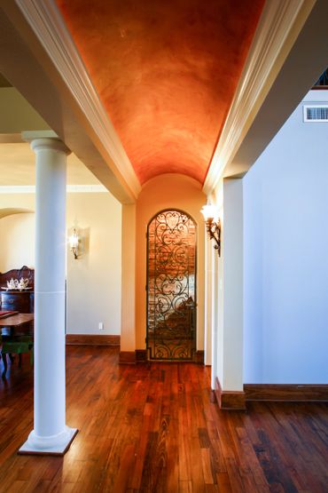 A hallway with a curved ceiling going to the wine cellar