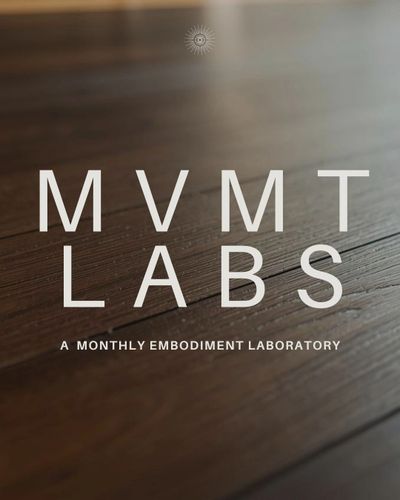 MVMT LABS logo on a wooden surface with the tagline 'A Monthly Embodiment Laboratory'.