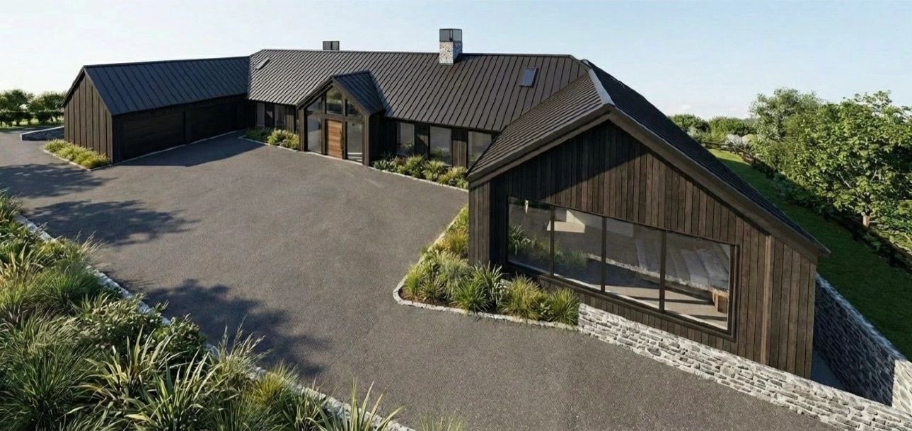 Modern black wooden house with large windows and stone foundation.