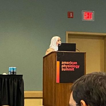 Two colleagues collaborating over a laptop in an office setting.
