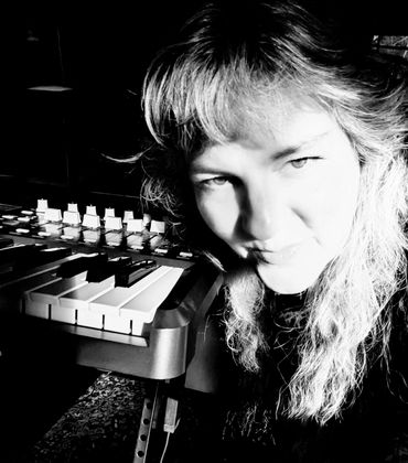 Black and white portrait of a woman with a keyboard instrument.