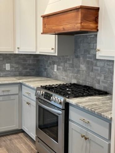 Kitchen designed with Custom Cabinetry, stone countertops and tile backsplash