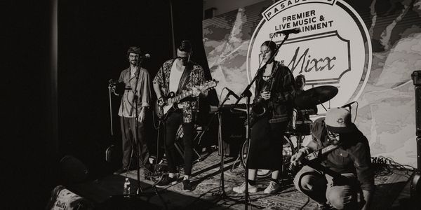 Black and white photo of a band performing live on stage at Pasadena's Mixx.