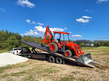 landoll truck towing construction equipment