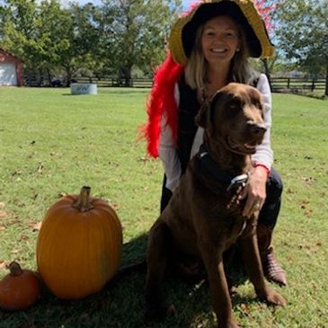Lynn Hawkins pictured with the Chocolate Lab Charlie.