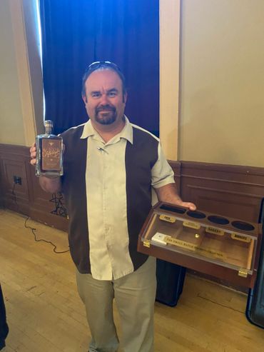 Raffle Winner with a bottle of Orphan Barrel